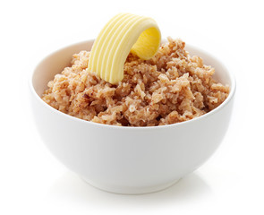 Bowl of buckwheat porridge isolated on white