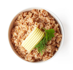 Bowl of buckwheat porridge isolated on white