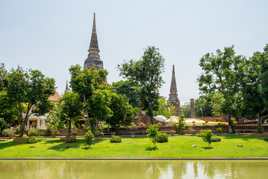 Stupa and buddha statue in park at wat yai chaimongkol temple,ayutthaya,thailand