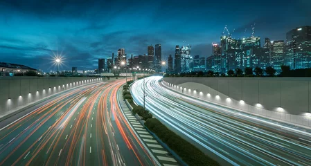 Photo sur Plexiglas construction de la ville Mouvement de la lumière de la voiture avec les toits de la ville de Singapour au crépuscule dans un ton dramatique
