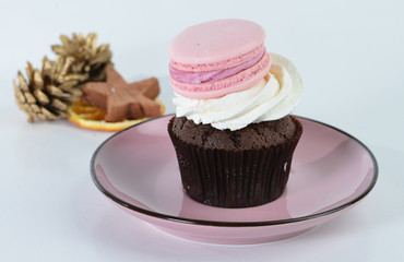 Still, delicious cake with macaroon on a gray background