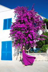 Europe Greece Santorini travel vacation. Woman in blowing dress