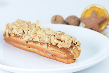 delicious eclairs on background cup of coffee