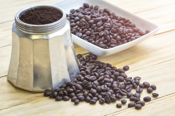 Fresh coffee beans and ancient coffee maker.