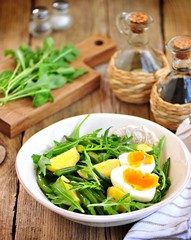 Vegetable salad with green beans, potatoes, arugula, eggs and olive oil. Vintage style.