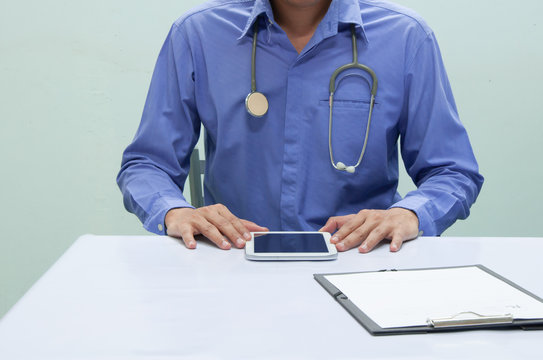 Doctor working with tablet at desk