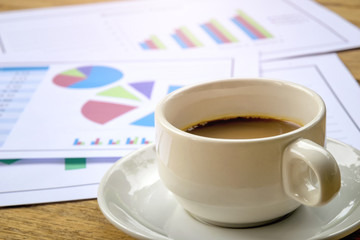 Home office - Businessman and coffee data document report pie chart form on wooden table.