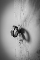 Old iron bolt door in a wall. Black and white