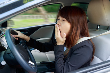 Fototapeta na wymiar Closeup portrait sleepy, tired, close eyes young woman driving