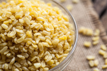 fried green gram in bowl on sackcloth and wooden background