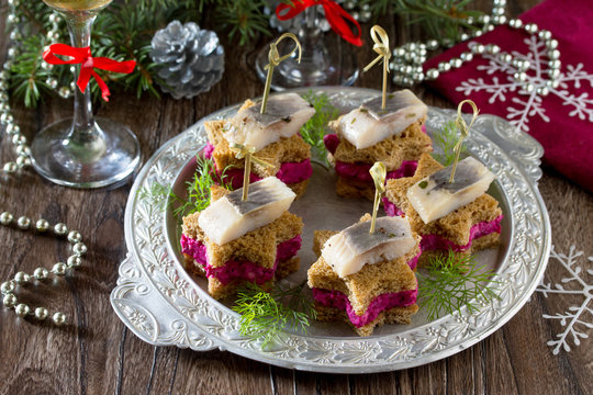 Holiday appetizer: Canapes in the form of a star with pickled he