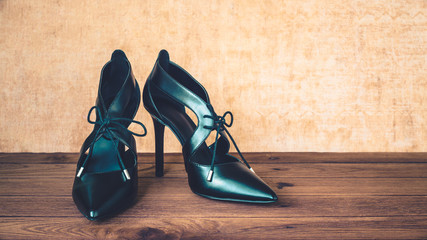 Black high heel shoes on wooden background