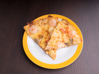 shrimp cocktail pizza with tomato and pineapple on brown wood table