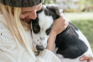 Young woman with cute puppy playing outdoor