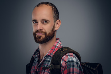 Bearded male in a shirt with backpack.