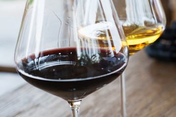 Glasses of Red and White Wine Close Up on Wooden Background