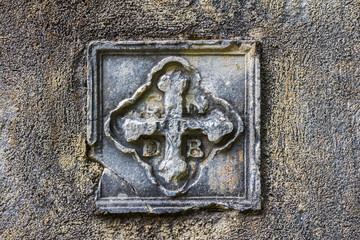 Ancient bas-relief in the form of a Christian cross on the church wall. Kotor. Montenegro
