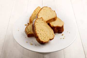 gugelhupf sprinkled with powdered sugar on a cake stand