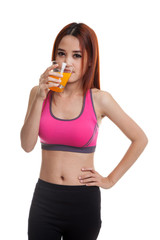 Beautiful Asian healthy girl drinking  orange juice.