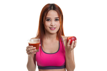 Beautiful healthy Asian girl with tomato juice and apple.