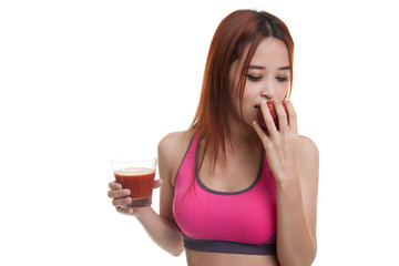 Beautiful healthy Asian girl with tomato juice and apple.