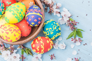 Easter eggs and spring flowers on wooden background