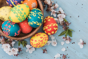 Easter eggs and spring flowers on wooden background