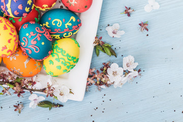 Easter eggs and spring flowers on wooden background