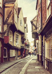 Fototapeta na wymiar The Shambles, a medieval street in York, England, UK. Toned image. Added grunge texture