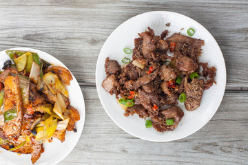 Spicy cumin lamb - traditional Uyghur dish  from Xinjiang region in China. Twice cooked pork - traditional Chinese dish from Sichuan region 