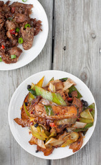 Twice cooked pork - traditional Chinese dish from Sichuan region . 
Spicy cumin lamb - traditional Uyghur dish  from Xinjiang region in China. 