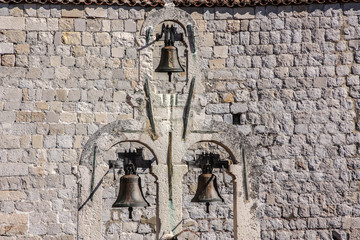 3 Bells inside a stone wall