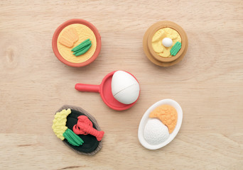 Toy food / View of miniature toy food on wood background. Top view. Flat lay.