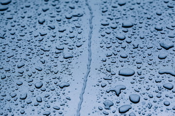 Water and Raindrops on Blue Metal Car 