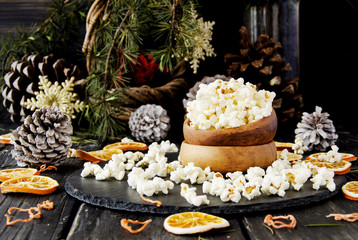 popcorn in a wooden plate on the background of Christmas