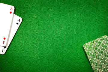 Cards on green felt casino table background