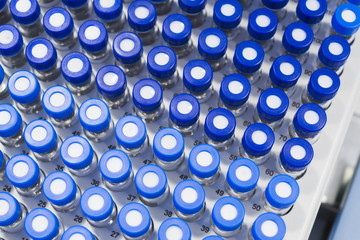Rows of glass vials in the tray automatic liquid dispenser.
