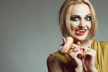 Fashion & Gluttony Concept. Portrait of luxurious funny blonde with donut