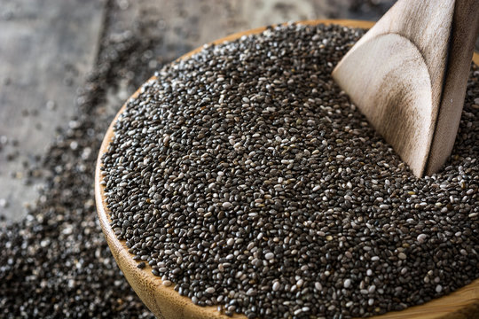 Chia seeds in a bowl on wooden table

