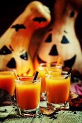 Halloween cocktail, pumpkin orange drink with spices. Dark vinta