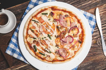 Delicious fresh pizza served on wooden table with coffee