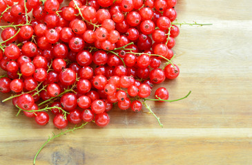 Health Benefits of Redcurrant.
Redcurrant on wooden background with Space for write a message.
