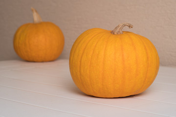 Yellow pumpkin on white garden table