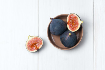 Top flat view: fresh figs on white wooden table