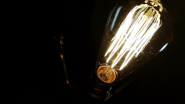 An old lamp turns on and off with vintage bulb.