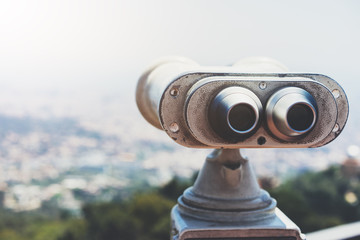 Touristic telescope look at the city with view of Barcelona Spain, close up old metal binoculars on...