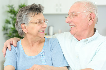 elderly couple having a laugh