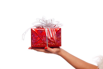 Christmas. Photo of Santa Claus gloved hand with red gift box, on a White background, isolated