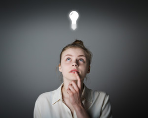 Girl in white and light bulb