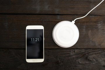 White smartphone and charging pad. © Daniel Jędzura